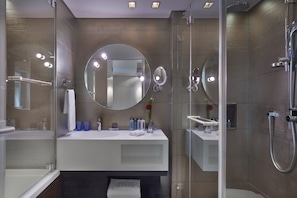 A modern bathroom with a glass-enclosed shower, a white vanity, and a large mirror. - Royal Beach Tel Aviv by Isrotel exclusive (Tel Aviv)