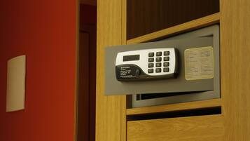 A built-in telephone in a wooden cabinet with a wall-mounted light and a small instruction card.