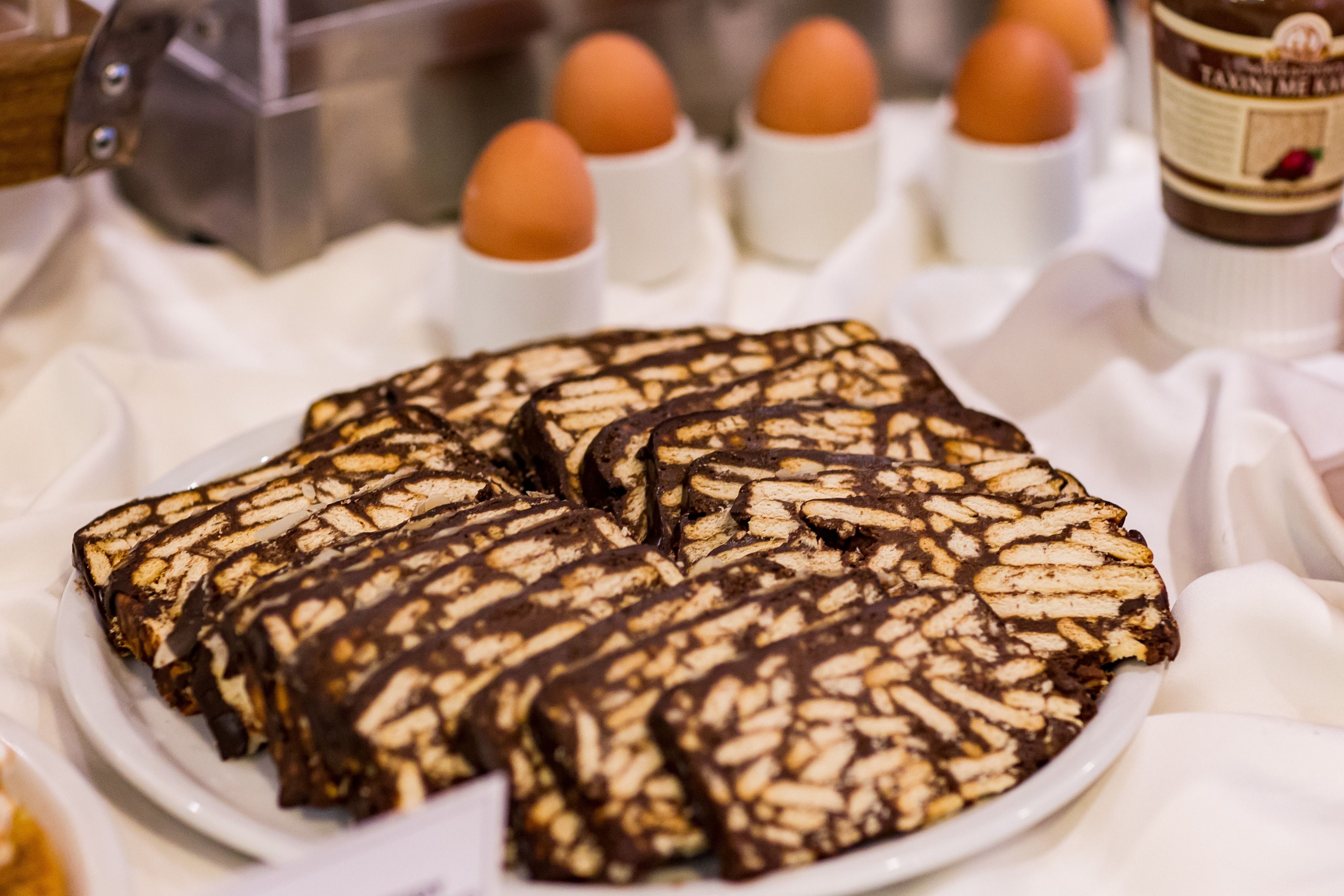 A plate of chocolate-covered biscuits with a decorative pattern.
