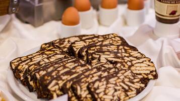 A plate of chocolate-covered biscuits with a decorative pattern.