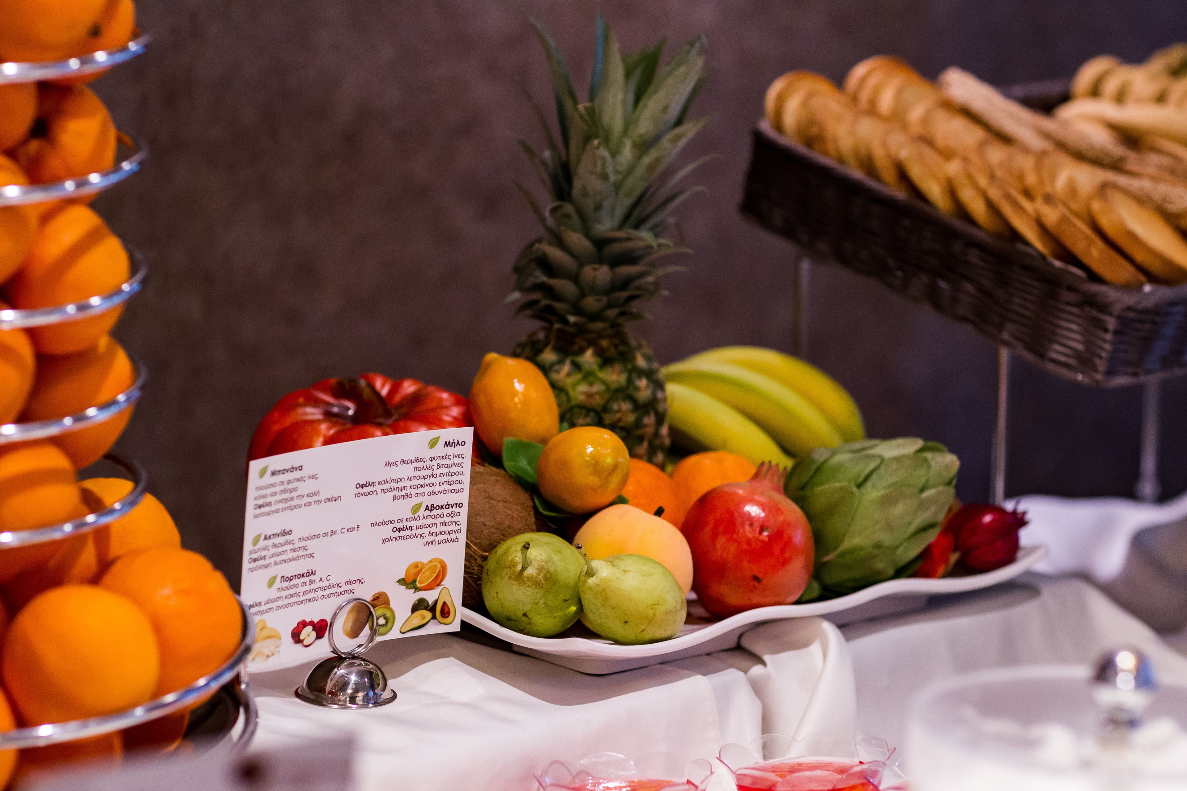 A buffet table with various fruits and bread.