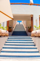 A staircase with blue-tiled steps leading to a building entrance.