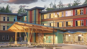 A multi-story hotel with a modern design, featuring a covered entrance and a landscaped outdoor area. - Hotel Zed Tofino (Tofino)
