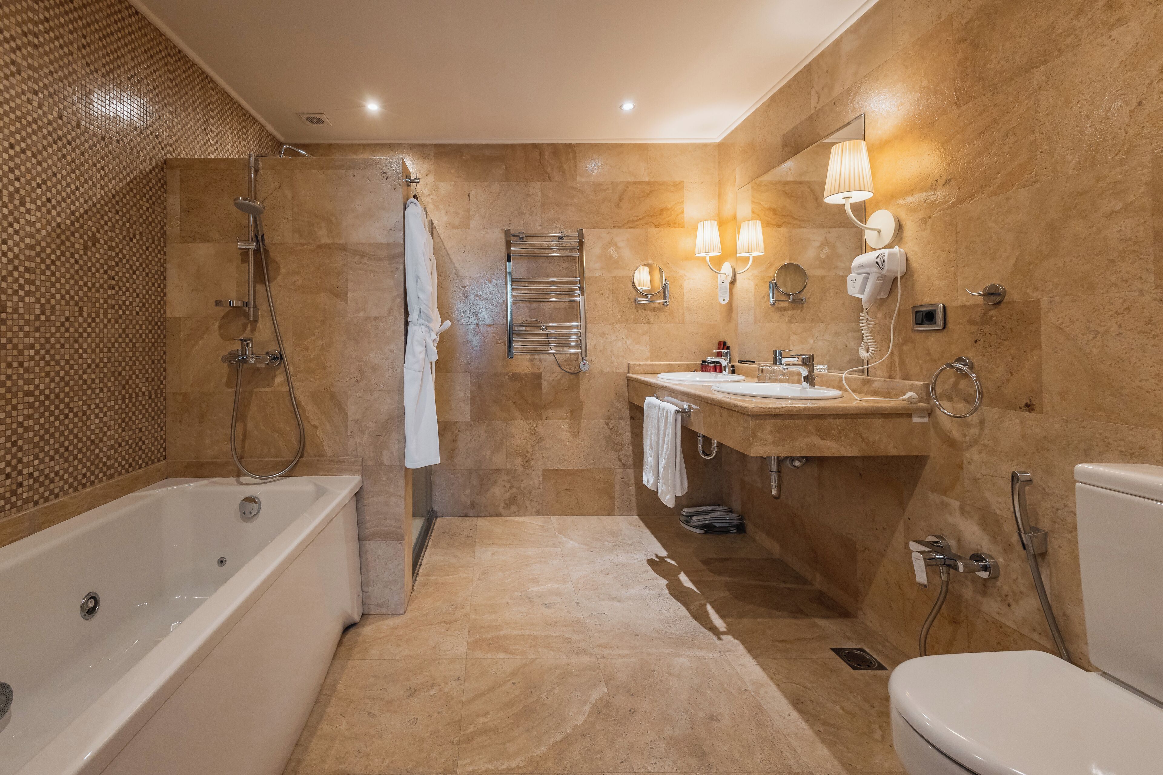 A modern bathroom with a bathtub, a sink, and a toilet.