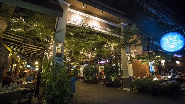 A restaurant with outdoor seating, a sign reading "Hua-Hin White," and a neon sign above. - Hua Hin White Sand (Hua Hin)