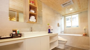 A modern bathroom with a white vanity, a toilet, and a bathtub. - Nagahiro Hotel (Taipei)