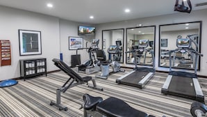 A gym with treadmills, stationary bikes, and weight machines. - Candlewood Suites Greenville by IHG (Greenville)