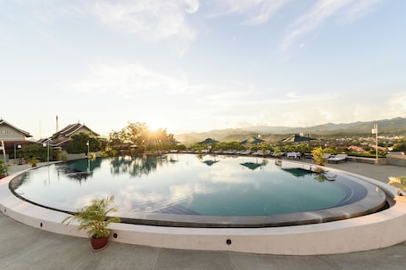 Outdoor pool, pool umbrellas, pool loungers. Luang Prabang View Hotel