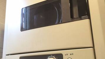 A Panasonic air conditioner with a control panel, including a dial and buttons.