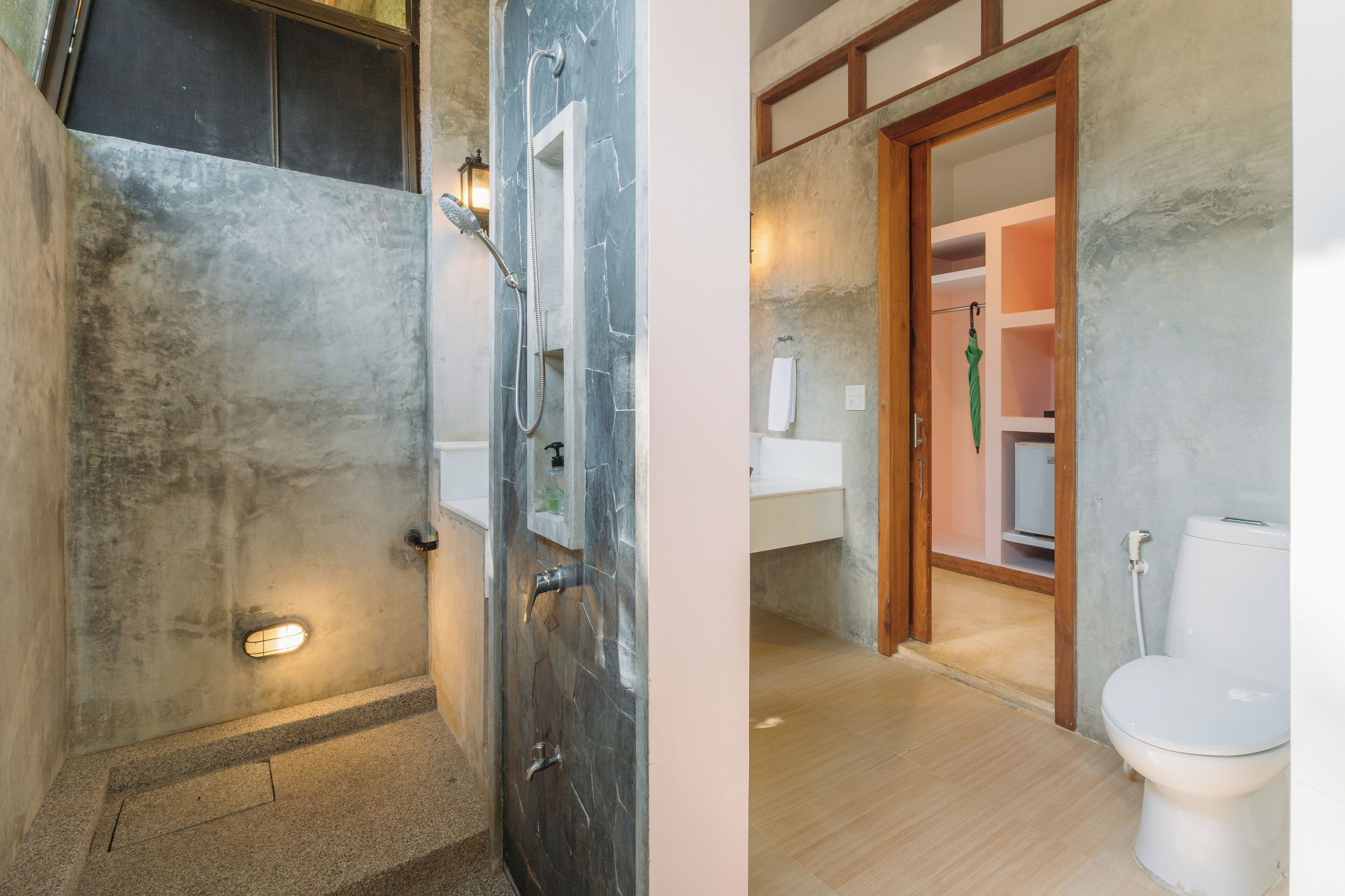A bathroom with a shower, toilet, and sink.