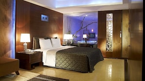 A modern hotel room with a large bed, bedside lamps, a desk, and a view of a spa area. - SLV Hotel Group - SLV Business Hotel (New Taipei City)