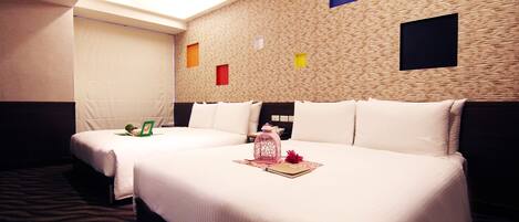 A hotel room with two beds, a patterned carpet, and a textured wall with colored squares.