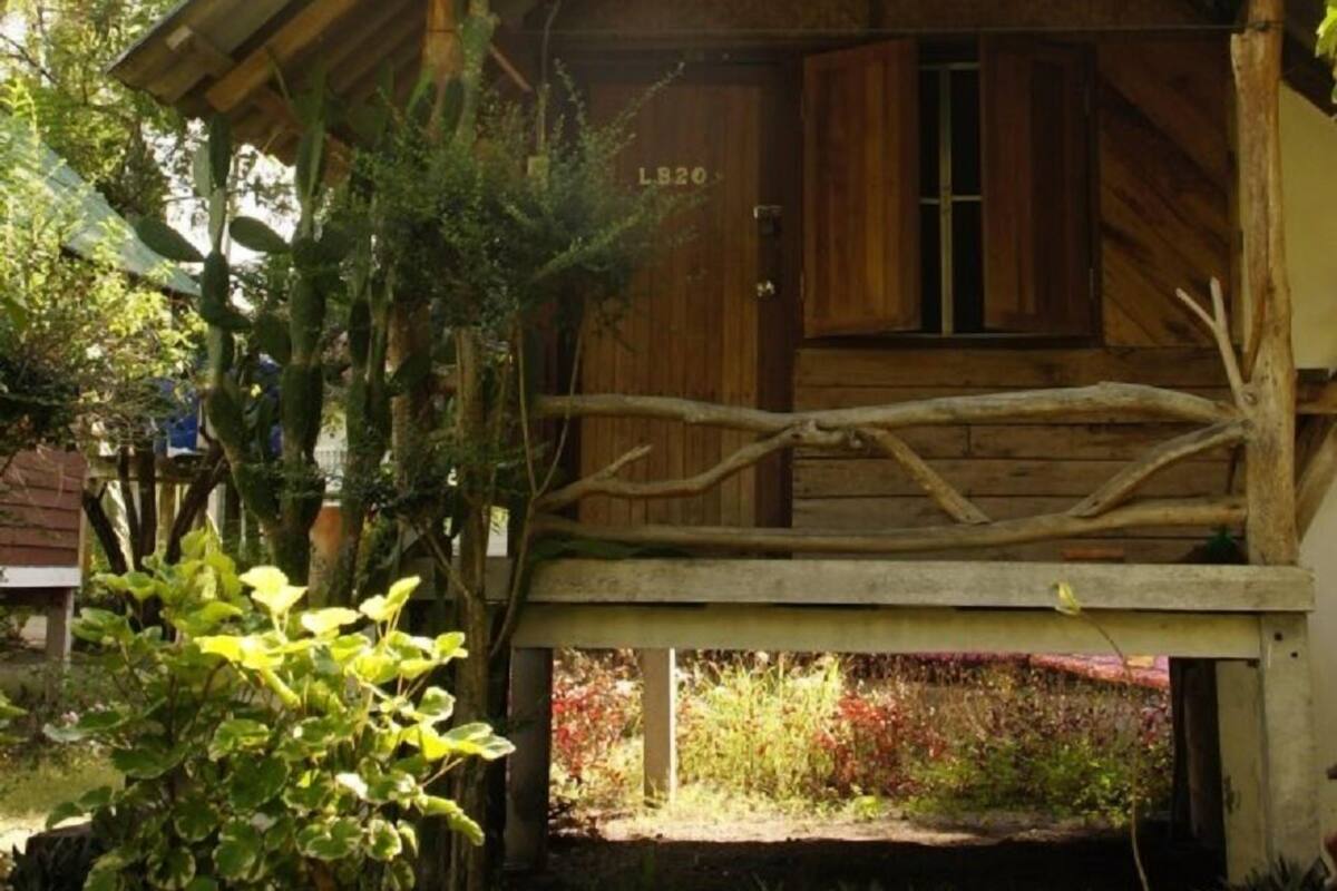 Ein Haus aus Holz mit geneigtem Dach und einer Veranda.