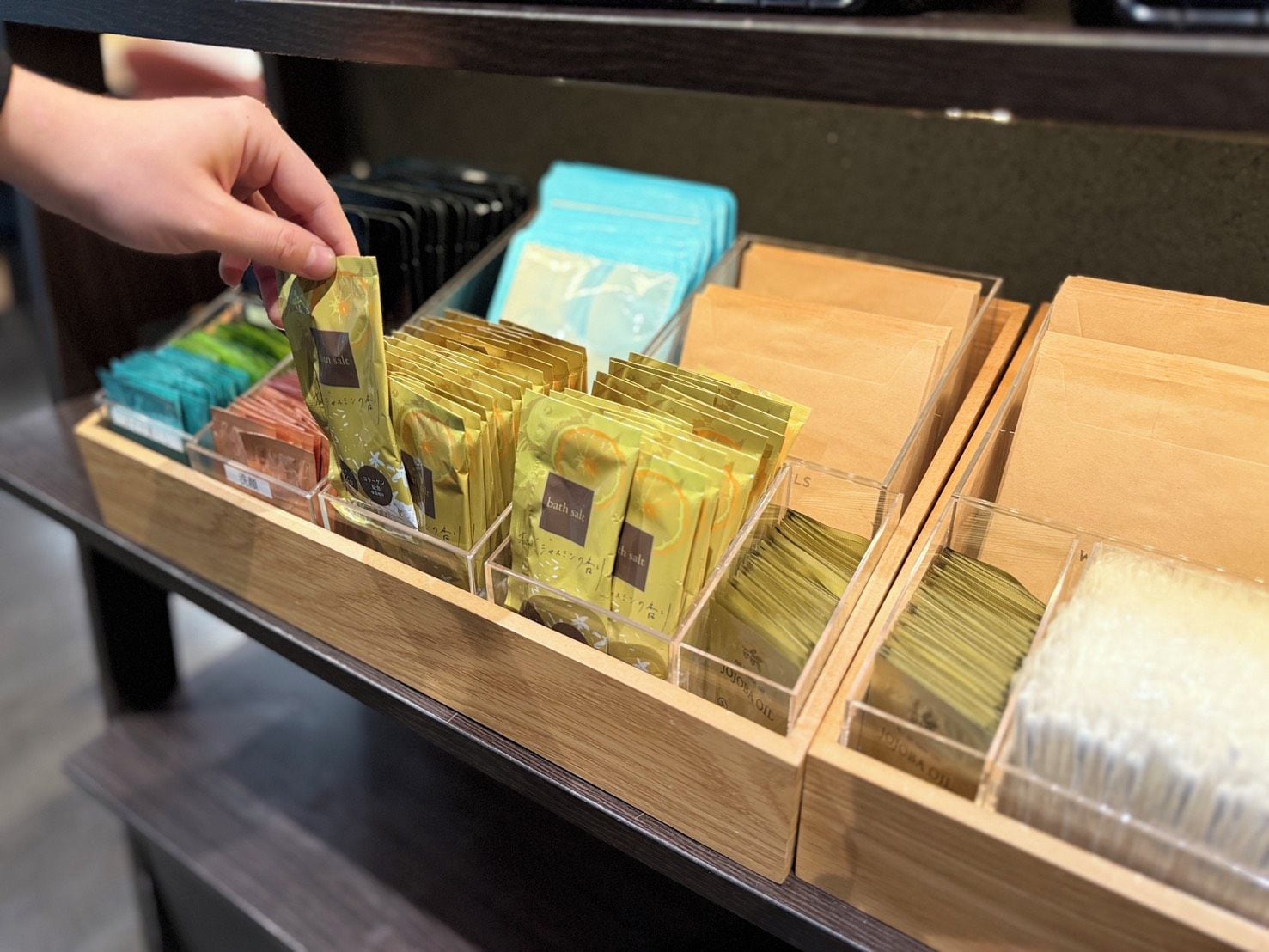 A display of bath salts in various colors and packaging styles.