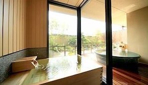 A room with a wooden bench, a glass table, and a view of greenery outside. - Mikasa Ryokan (Nara)