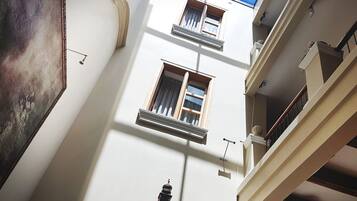 A multi-level interior with a skylight, balconies, and a staircase.