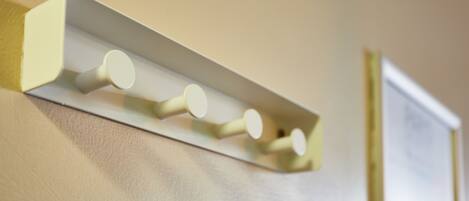 A wall-mounted light fixture with four cylindrical bulbs.