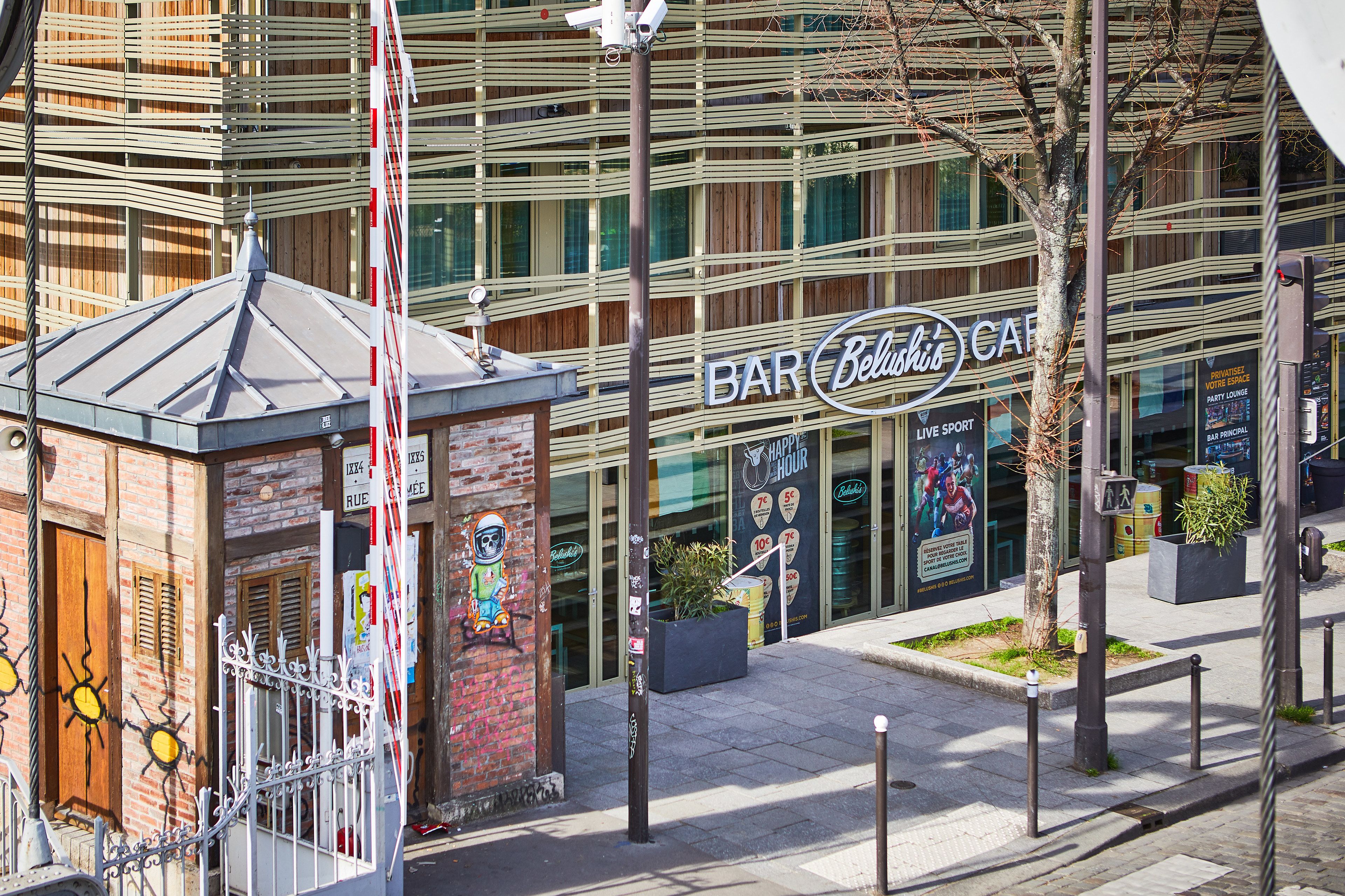 A modern building with a sign for 'BAR Belushi'.
