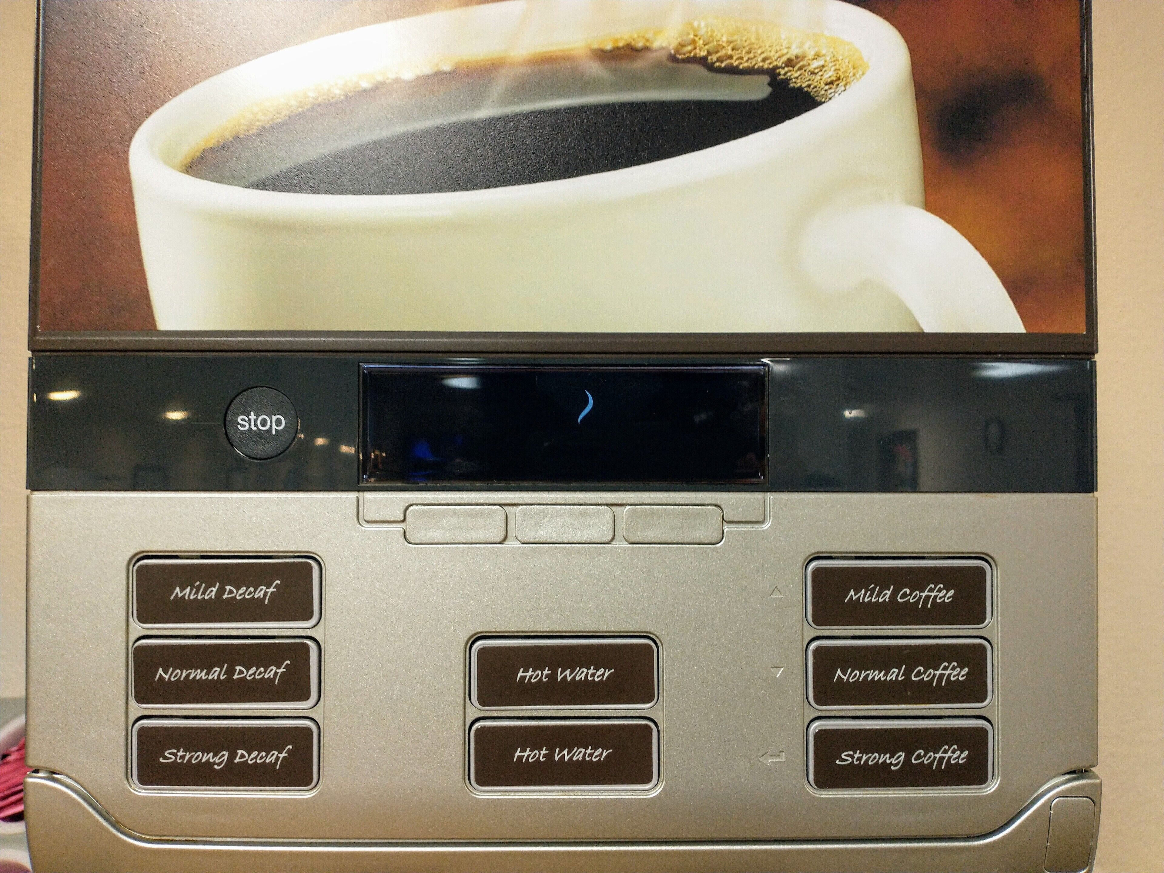 A coffee machine with buttons for different coffee and water settings.
