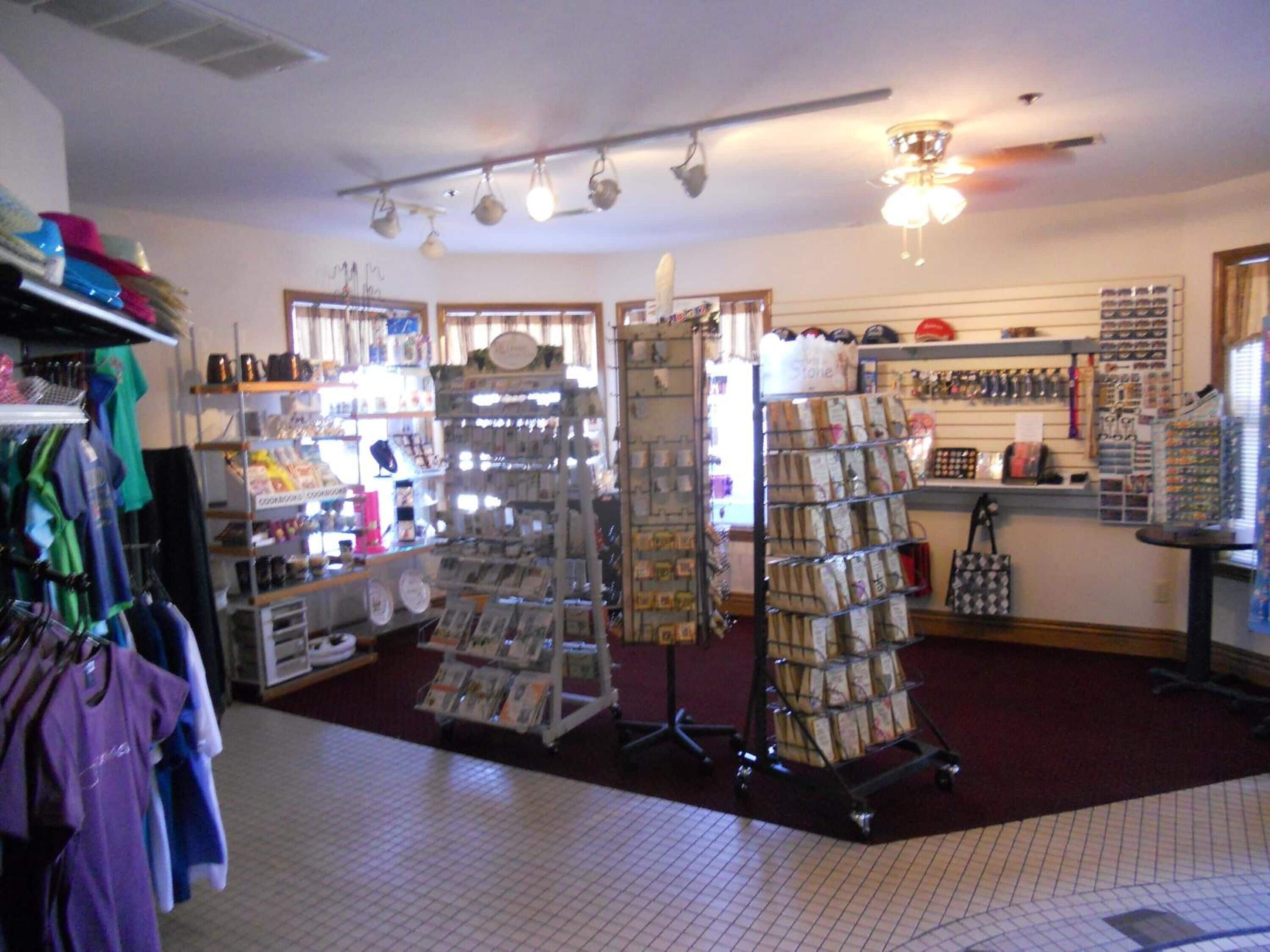 A retail store with various items on shelves and racks, including clothing and accessories.