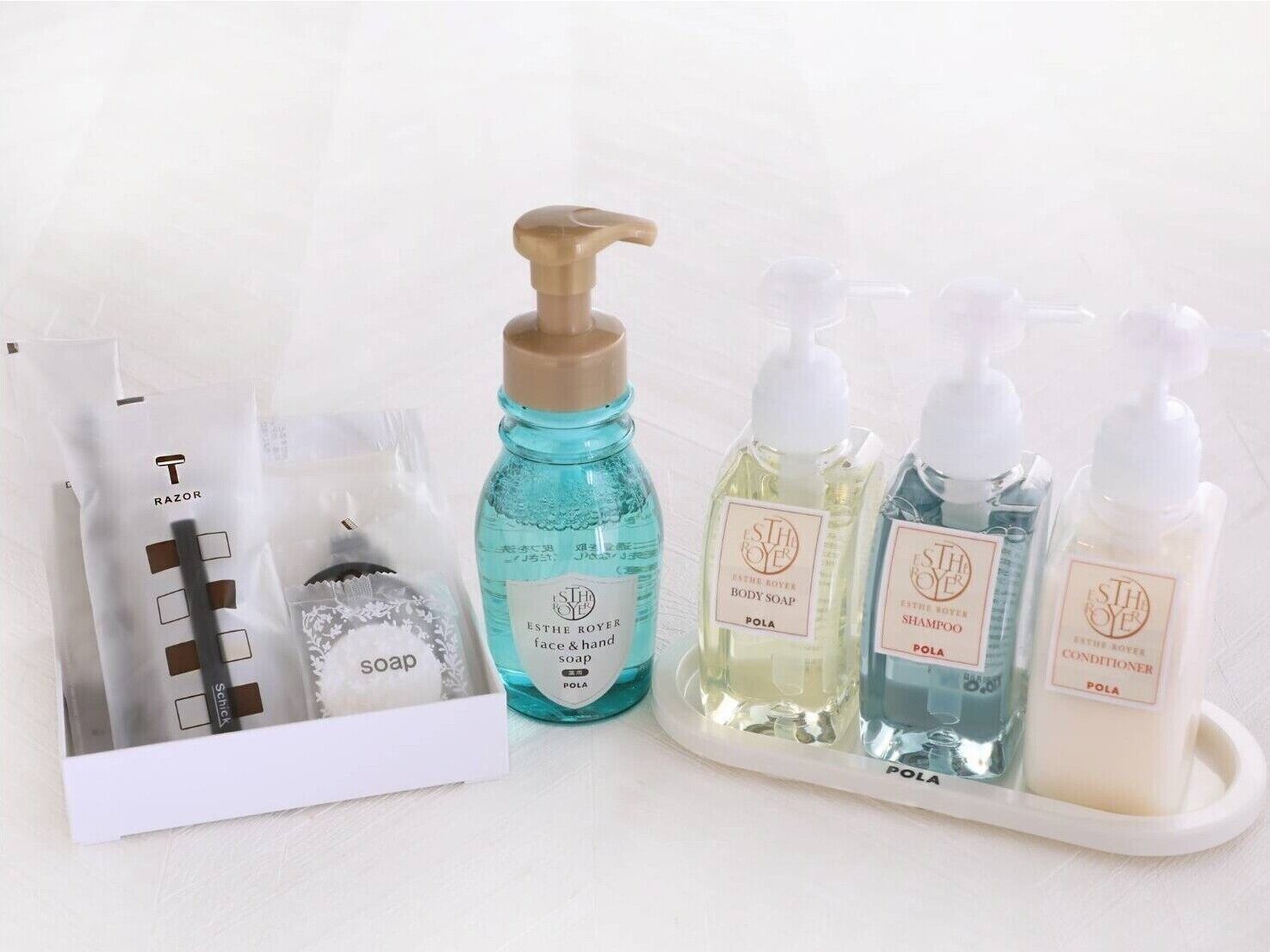 A set of toiletries including a razor, soap, and various body care products.