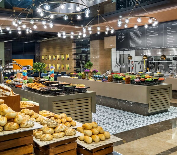 A buffet area with various food items and a menu board. - Radisson Blu Hotel, Istanbul Sisli (Istanbul)
