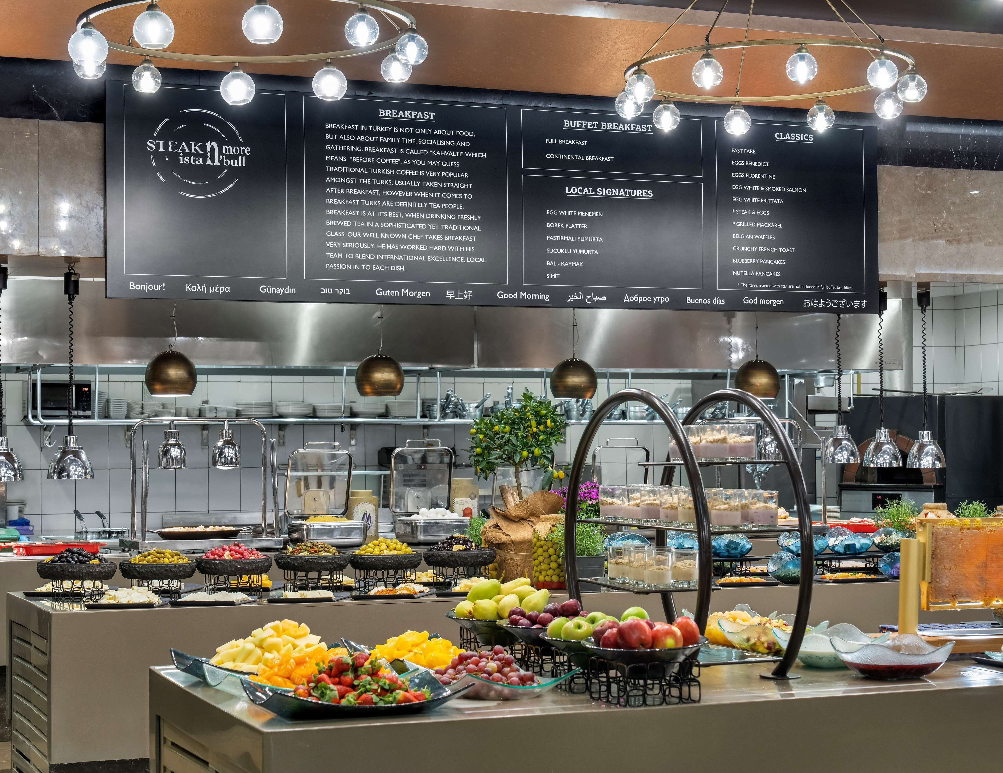 A buffet breakfast area with various food options and a menu board.