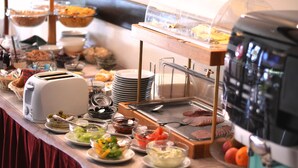A buffet setup with various food items, including salads, meats, and bread. - Park Hotel Pruhonice (Pruhonice)