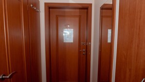 A hallway with wooden doors and a wooden floor. - Penzion Fan (Karlovy Vary)