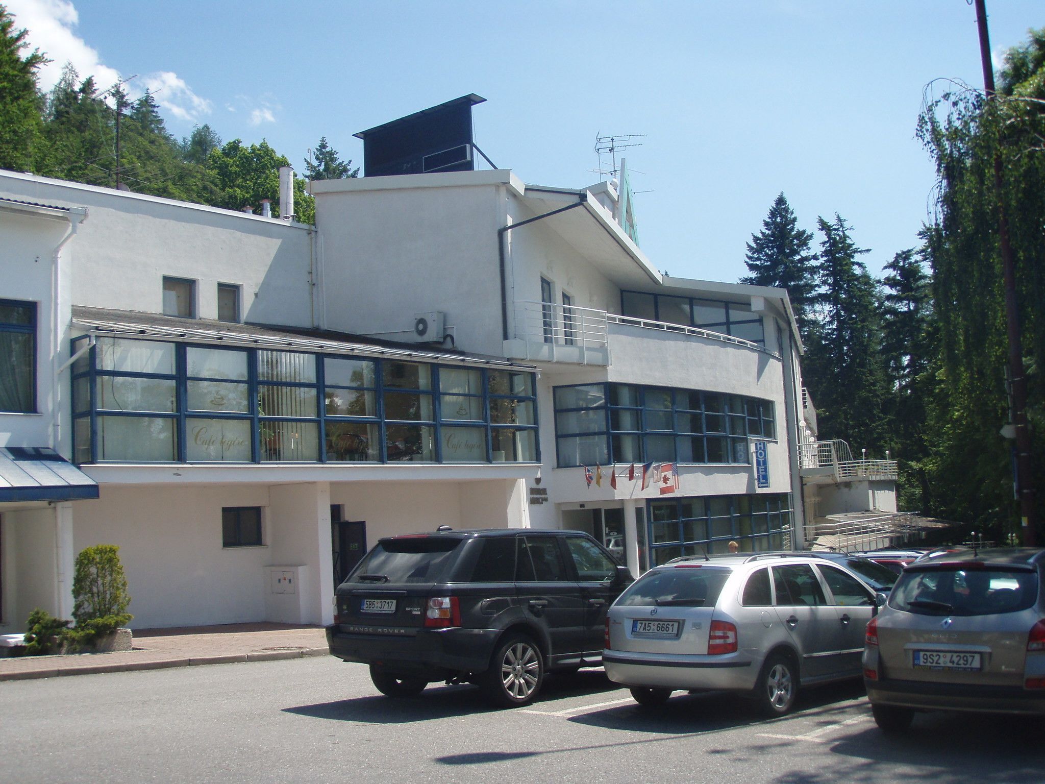 A two-story building with a cafe on the ground floor and a hotel on the upper floor.