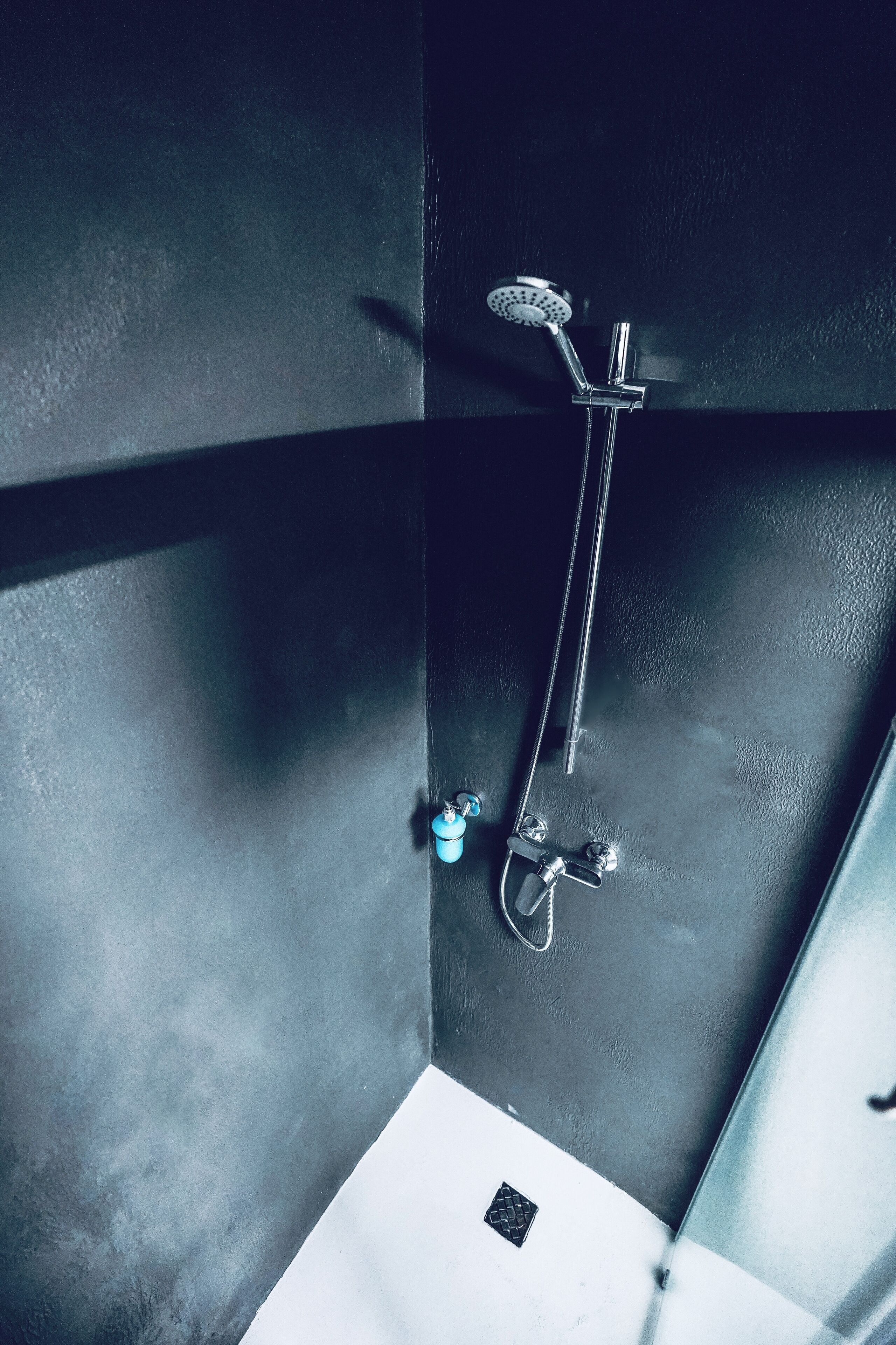 A modern bathroom with a shower, a toilet, and a sink.