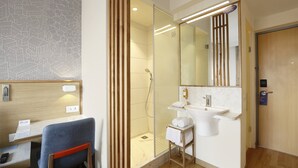 A modern bathroom with a glass-enclosed shower, a sink, and a mirror. - Holiday Inn Express Bengaluru Whitefield Itpl by IHG (Bengaluru)