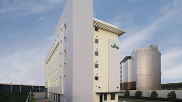 A modern building with a flat facade, multiple windows, and a logo on the side.