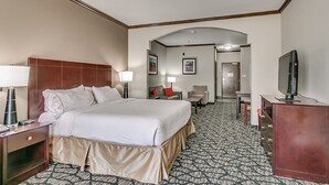 A hotel room with a large bed, bedside tables, a TV, a desk, and a chair. - Holiday Inn Express Hotel & Suites Lubbock South by IHG (Lubbock)