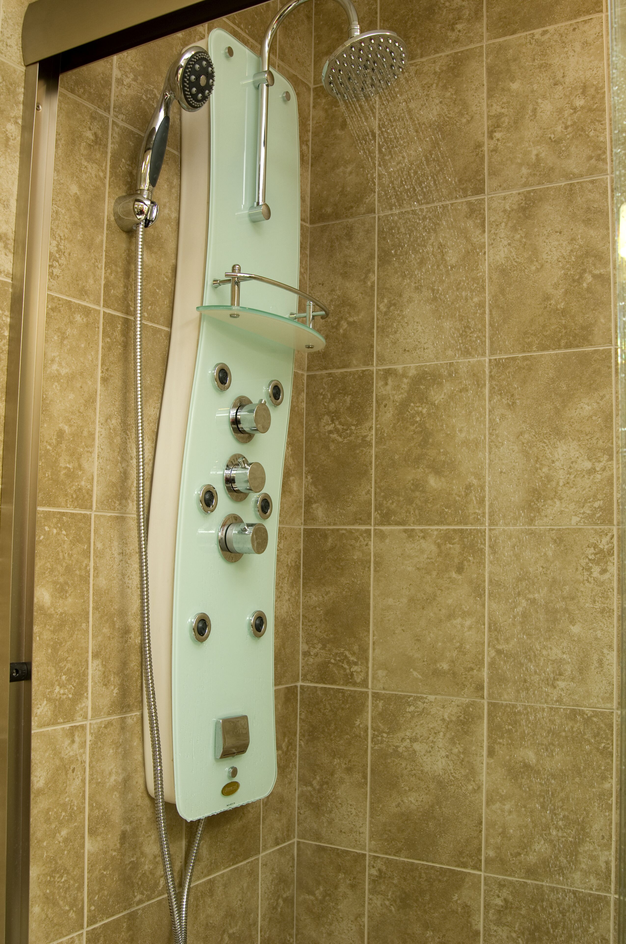 A shower with multiple controls and a handheld showerhead.