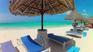 On the beach, white sand, beach umbrellas - Waikiki Zanzibar Resort (Pwani Mchangani)