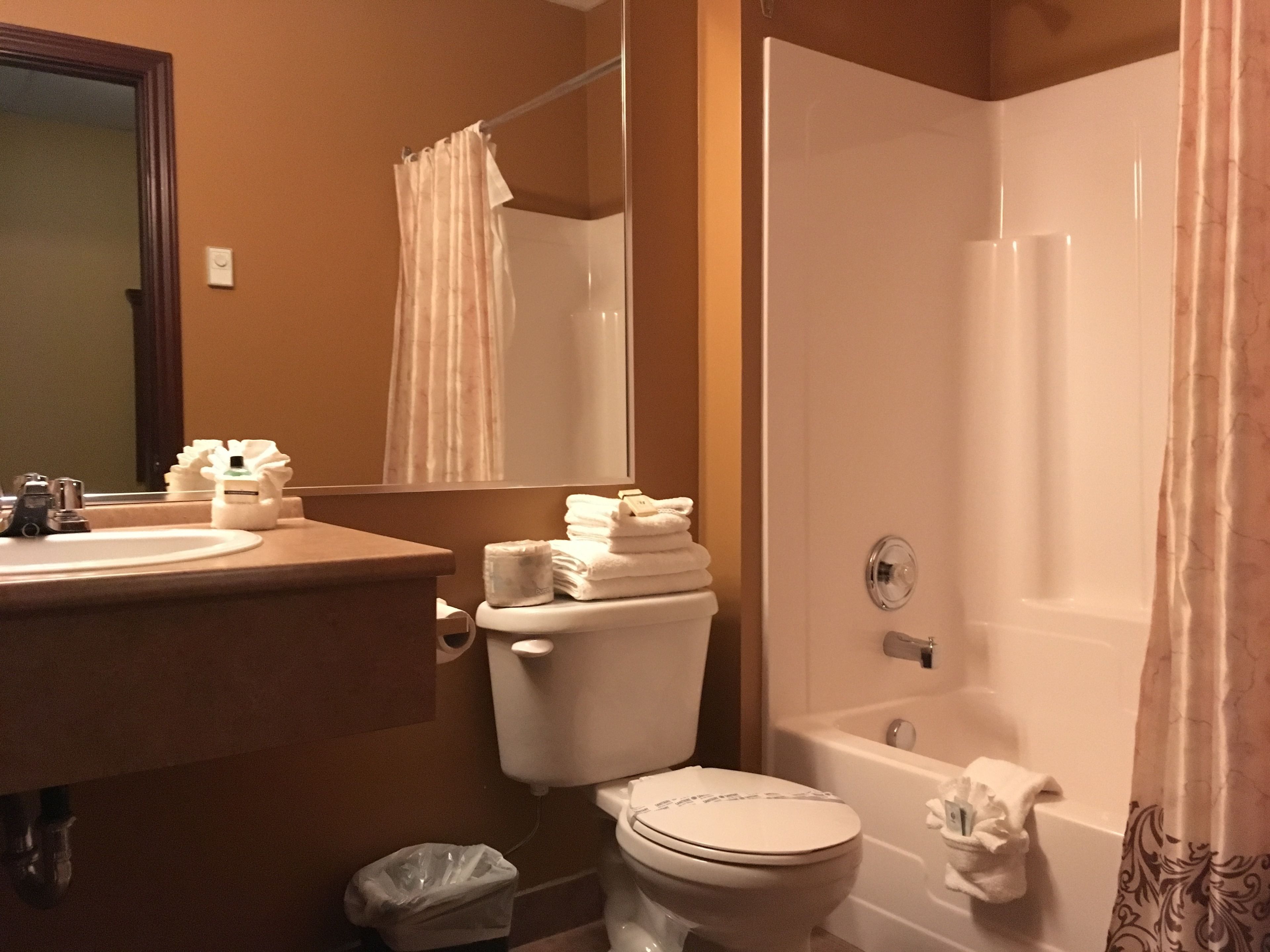 A bathroom with a toilet, sink, and bathtub.