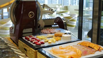 A sushi bar with various seafood and fruits displayed on a counter.