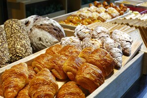 A variety of baked goods including breads and pastries displayed in wooden trays. - Jing An Shangri-La, Shanghai (Shanghai)