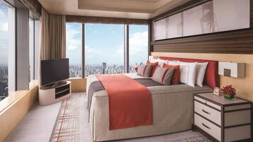 A modern hotel room with a large bed, a TV, a nightstand, and a city view.