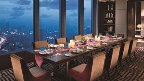 A dining area with a city view, large windows, and modern chandeliers. - Jing An Shangri-La, Shanghai (Shanghai)