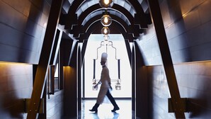 A corridor with a reflective floor, arched ceiling, and hanging light fixtures. - Jing An Shangri-La, Shanghai (Shanghai)