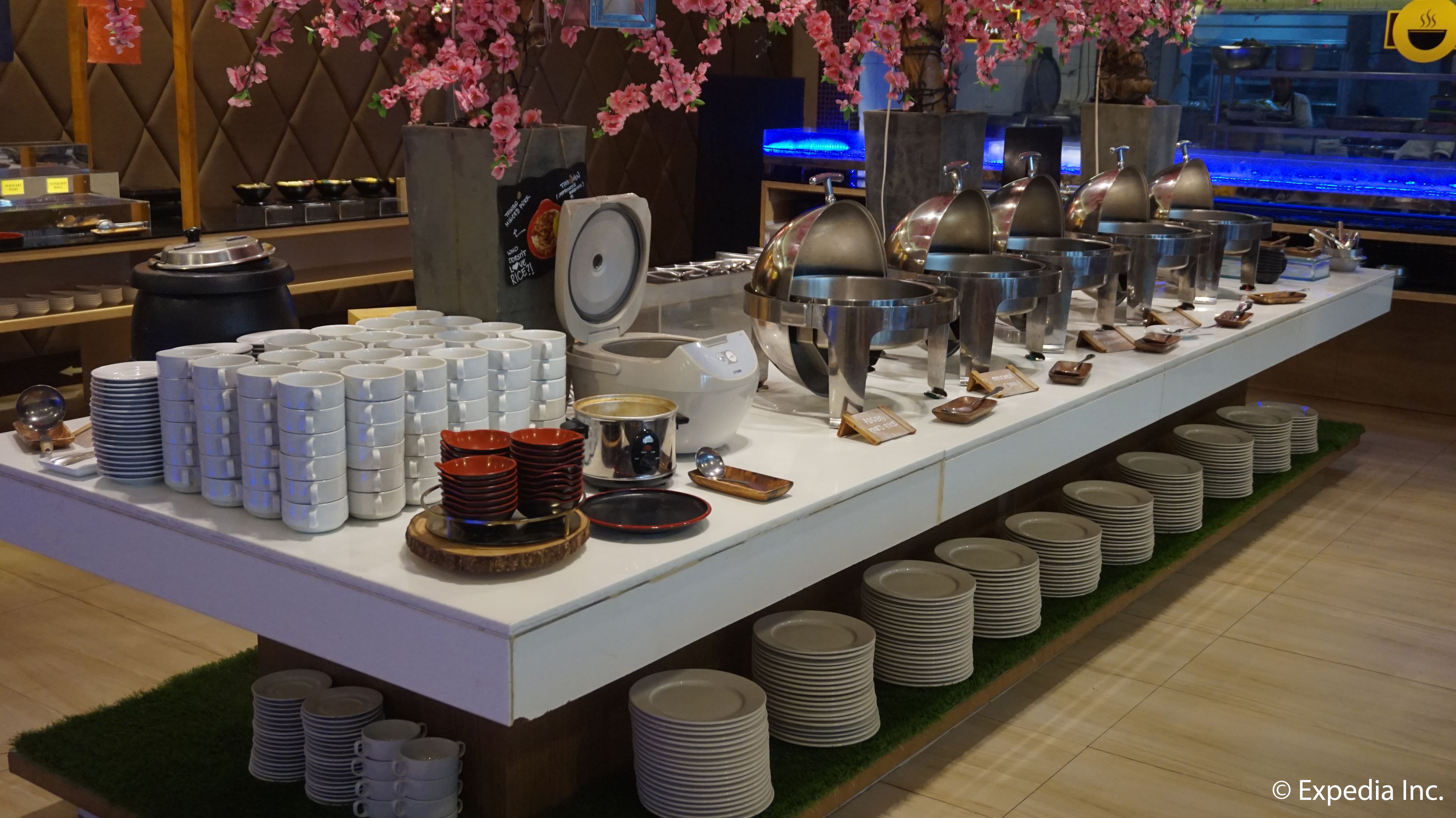 Una mesa de buffet con diversos platos y utensilios ordenados.