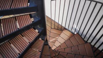 A spiral staircase with wooden steps and metal railings.