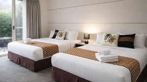 A hotel room with two beds, a window with curtains, a lamp, and a view of greenery outside. - De'Vine Escape (Dixons Creek)