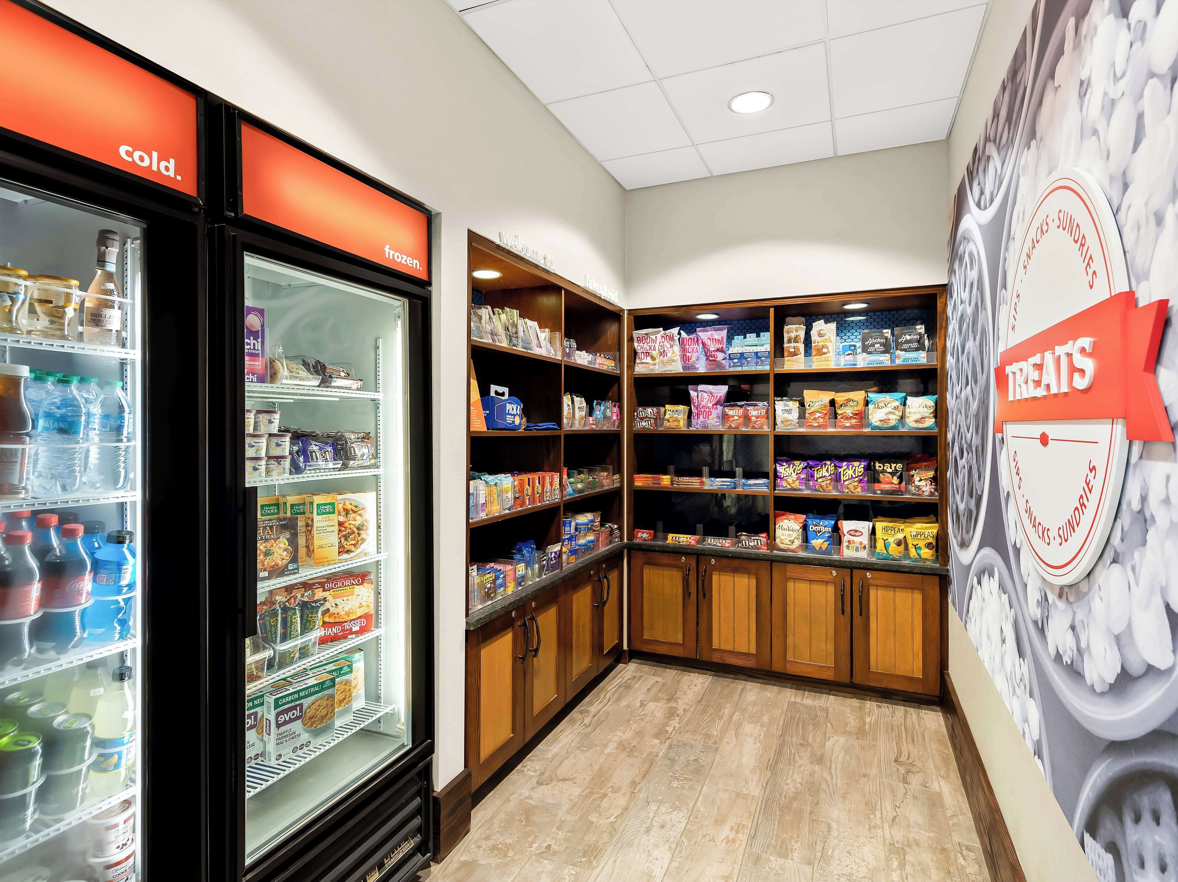 A snack and sundries section with a variety of packaged snacks and a refrigerated section with beverages.