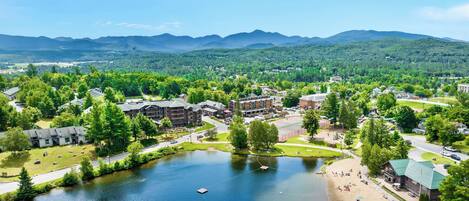 A lakeside hotel with multiple buildings, a dock, and a tennis court.