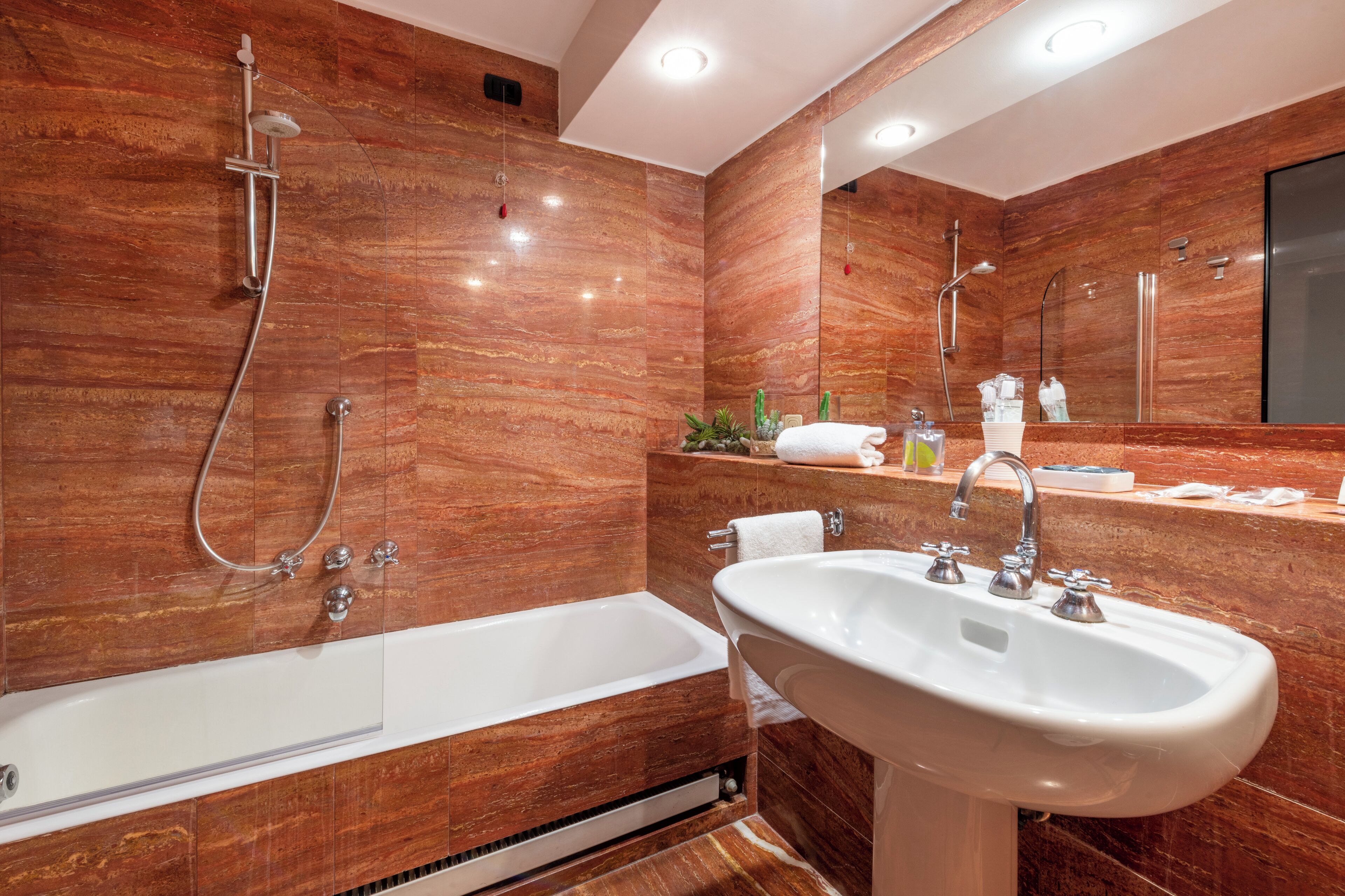 A modern bathroom with a large bathtub, a sink, and a shower.