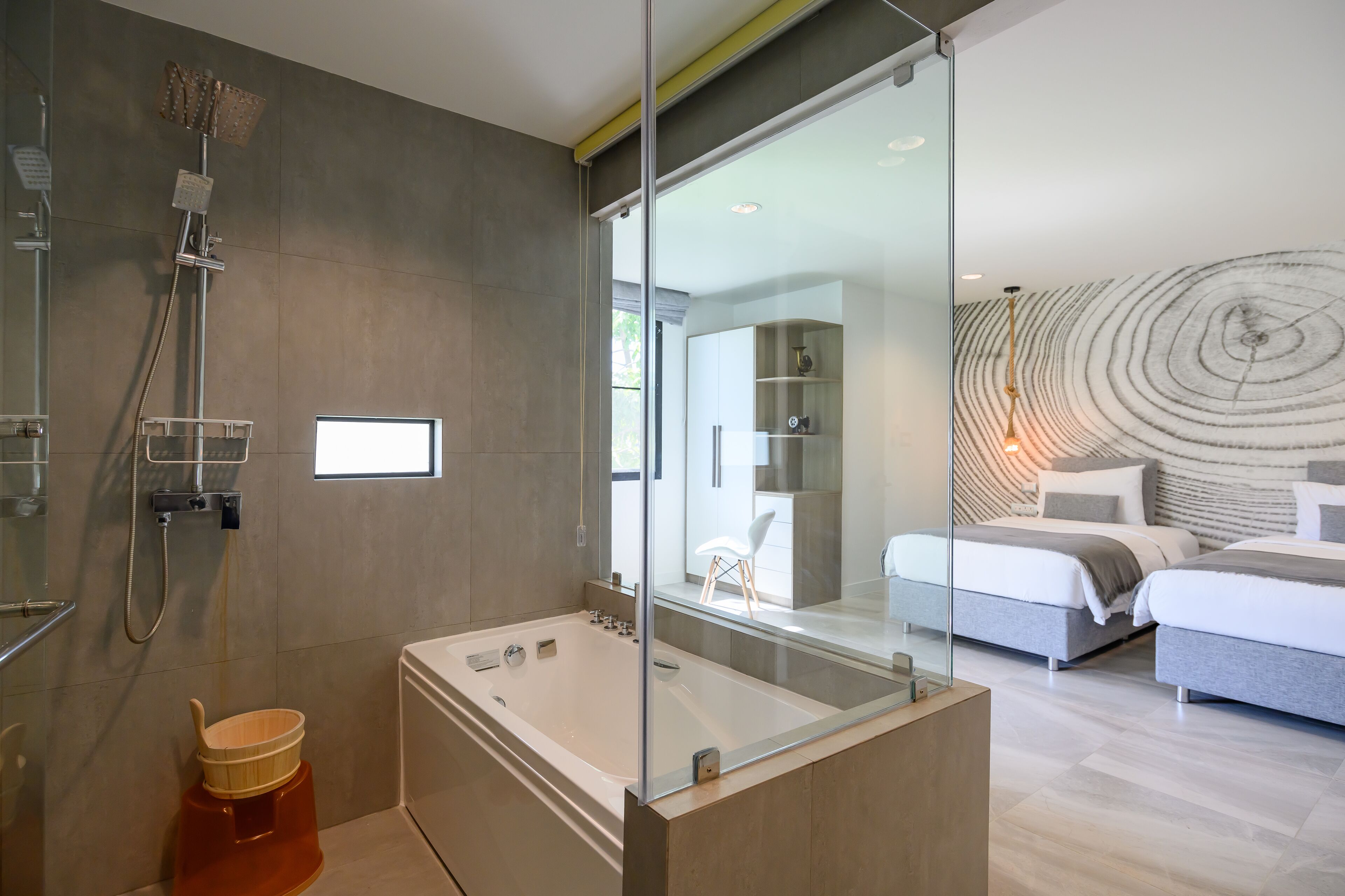 A modern bathroom with a glass-enclosed shower, a bathtub, and a toilet.