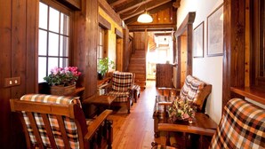 A wooden interior with a sofa, chairs, and a dining table. - Hotel Ristoro Vagneur (Saint-Nicolas)